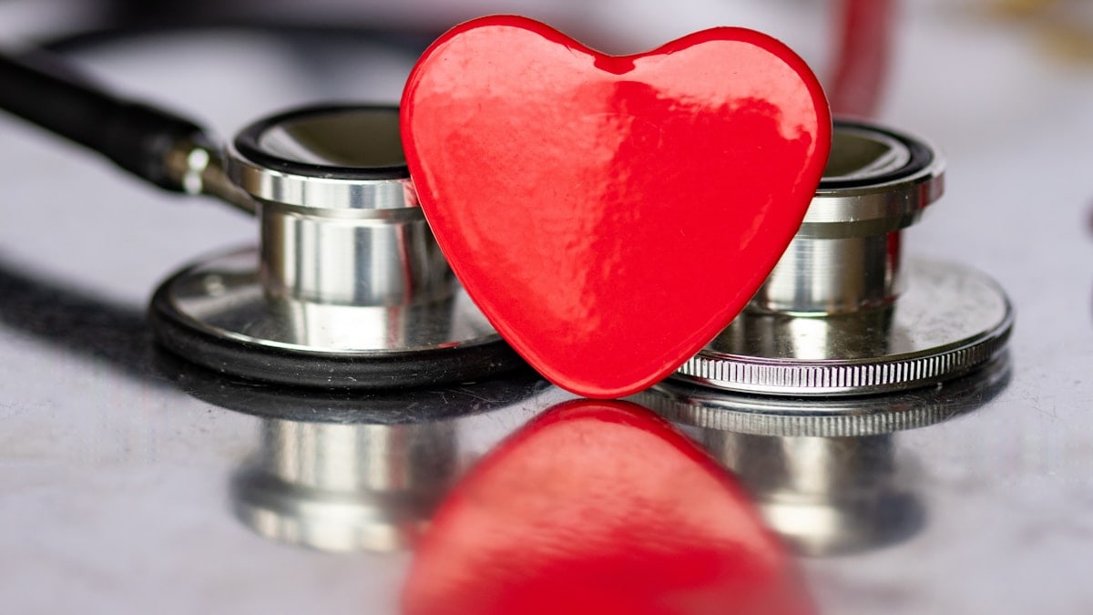 a red heart sitting on top of a stethoscope
